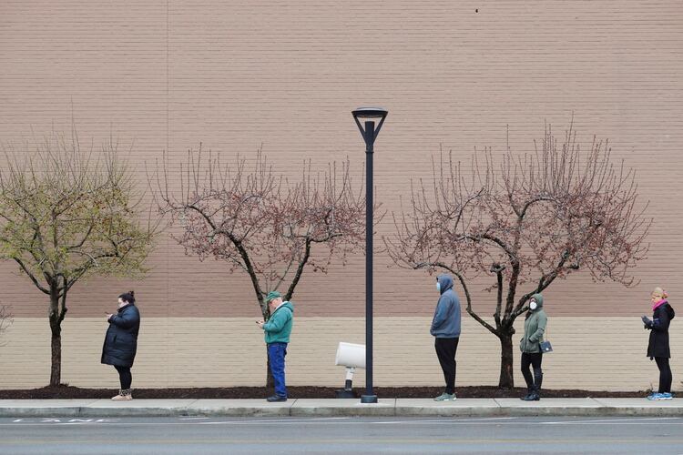 People line up at a safe social distance outside the grocery store amid the coronavirus disease (COVID-19) outbreak in Medford, Massachusetts, U.S., April 4, 2020. REUTERS/Brian Snyder