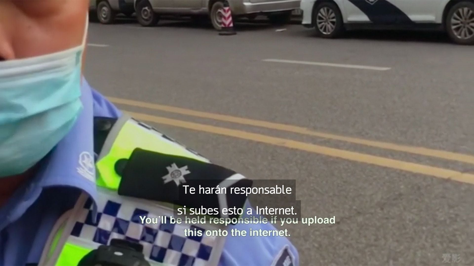 Un policía le prohíbe a una persona grabar con su teléfono celular en plena vía pública en Wuhan