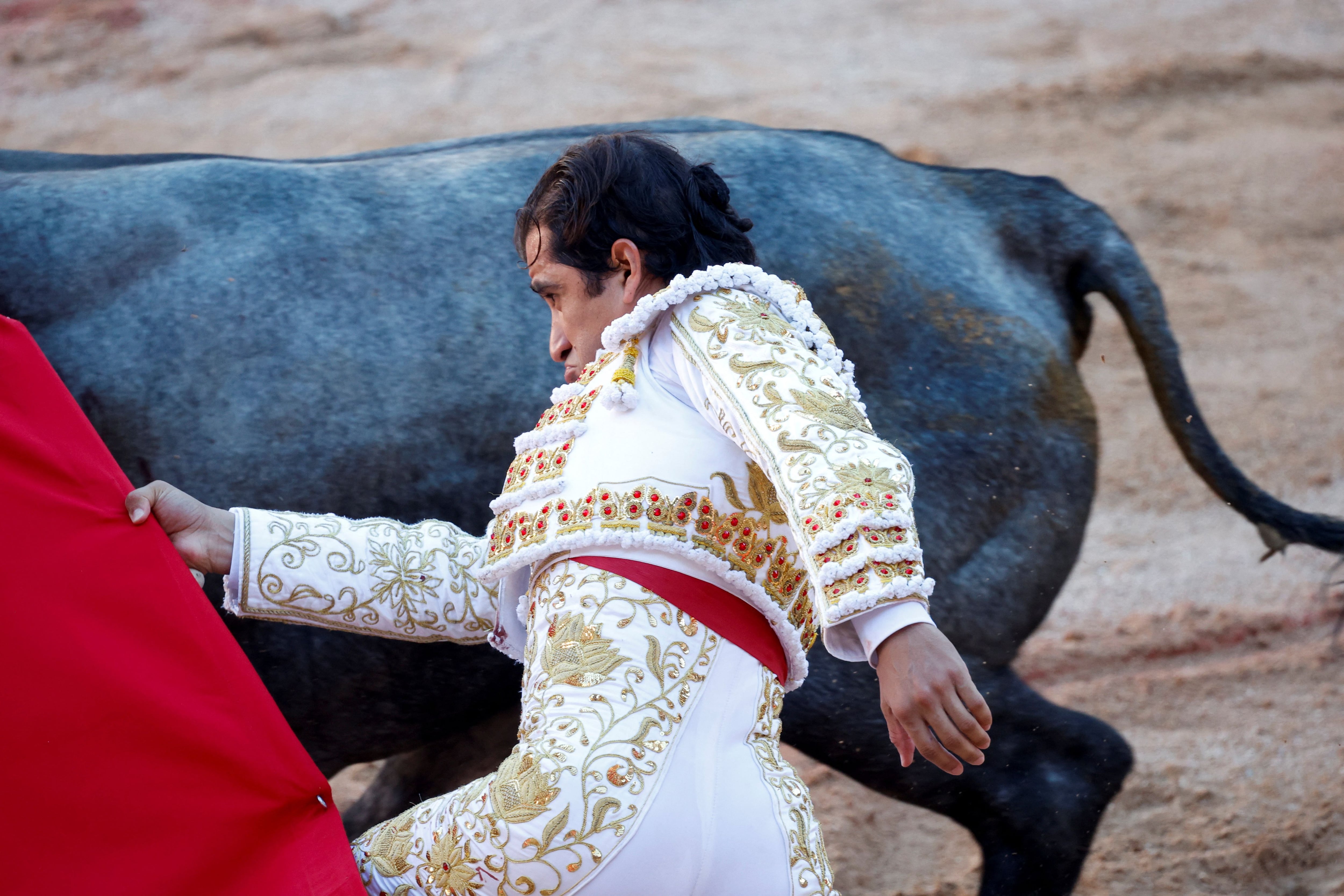 Mexican bullfighter Joselito Adame performs a pass during a bullfight at the San Fermin festival in Pamplona, Spain, July 9, 2022. REUTERS/Juan Medina