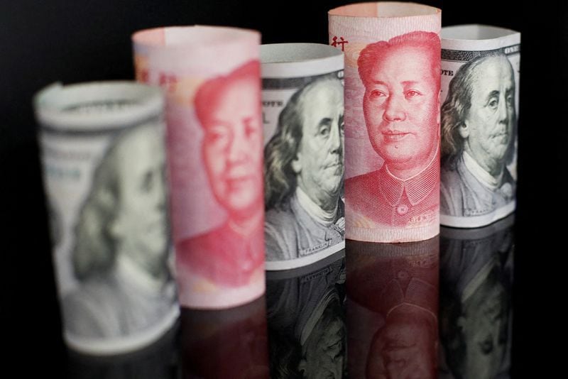 FOTO DE ARCHIVO: Billetes de yuan chino y de dólar estadounidense se ven en esta foto de ilustración. REUTERS/Florence Lo/Ilustración/Archivo