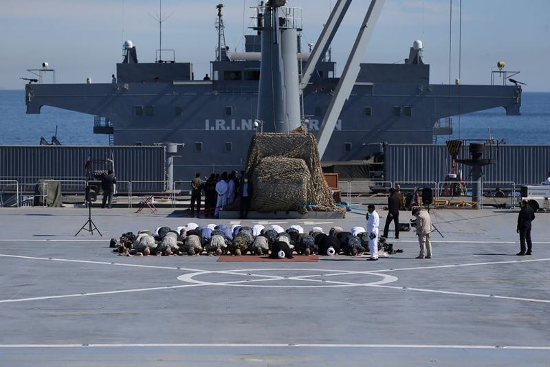Ccomandante militares iraníes y otros miembros de las fuerzas armadas orando en el buque de guerra Makran (Iran/WANA/via Reuters)