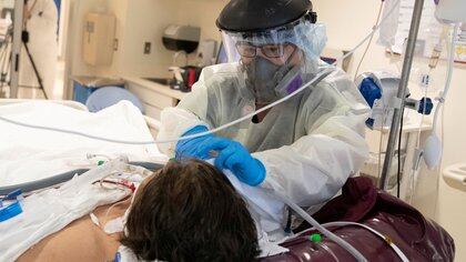 FILE PHOTO: Registered Nurse Monica Escobar, 49, checks on a coronavirus disease (COVID-19) patient, at LAC+USC Medical Center in Los Angeles, California, U.S., January 29, 2021. REUTERS/Lucy Nicholson/File Photo