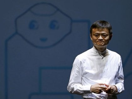 Jack Ma, founder and CEO of China's Alibaba Group, speaks in front of a photo of the eponymous SoftBank robot 