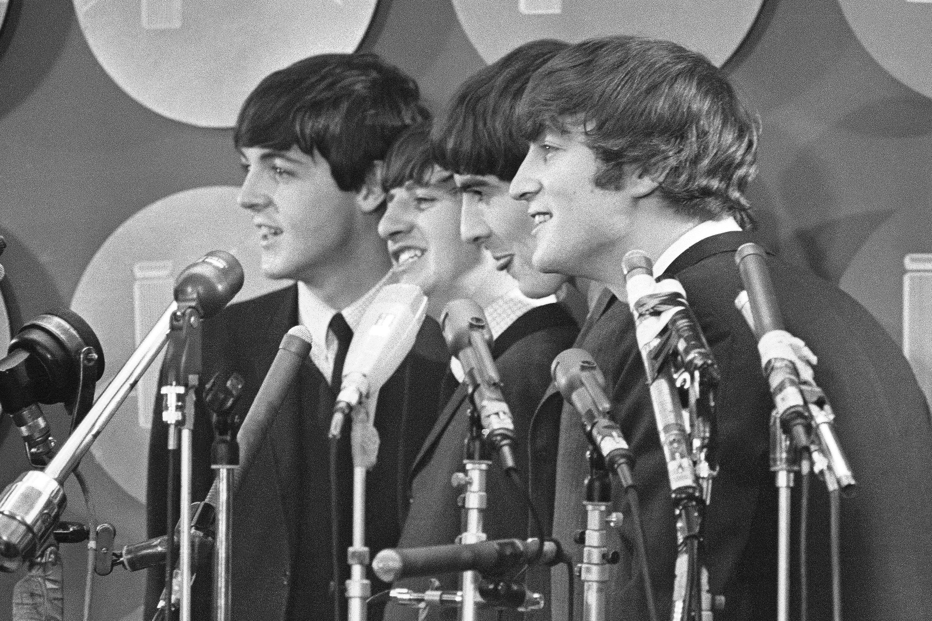 The Beatles hablan con medios de comunicación en el Aeropuerto Internacional Kennedy a su llegada el 7 de febrero de 1964 en Nueva York (Foto AP, archivo)