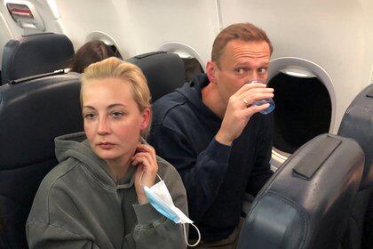 Russian opposition leader Alexei Navalny and his wife Yulia Navalnaya are seen on board a plane during a flight from Berlin to Moscow, January 17, 2021. REUTERS/Maria Vasilyeva