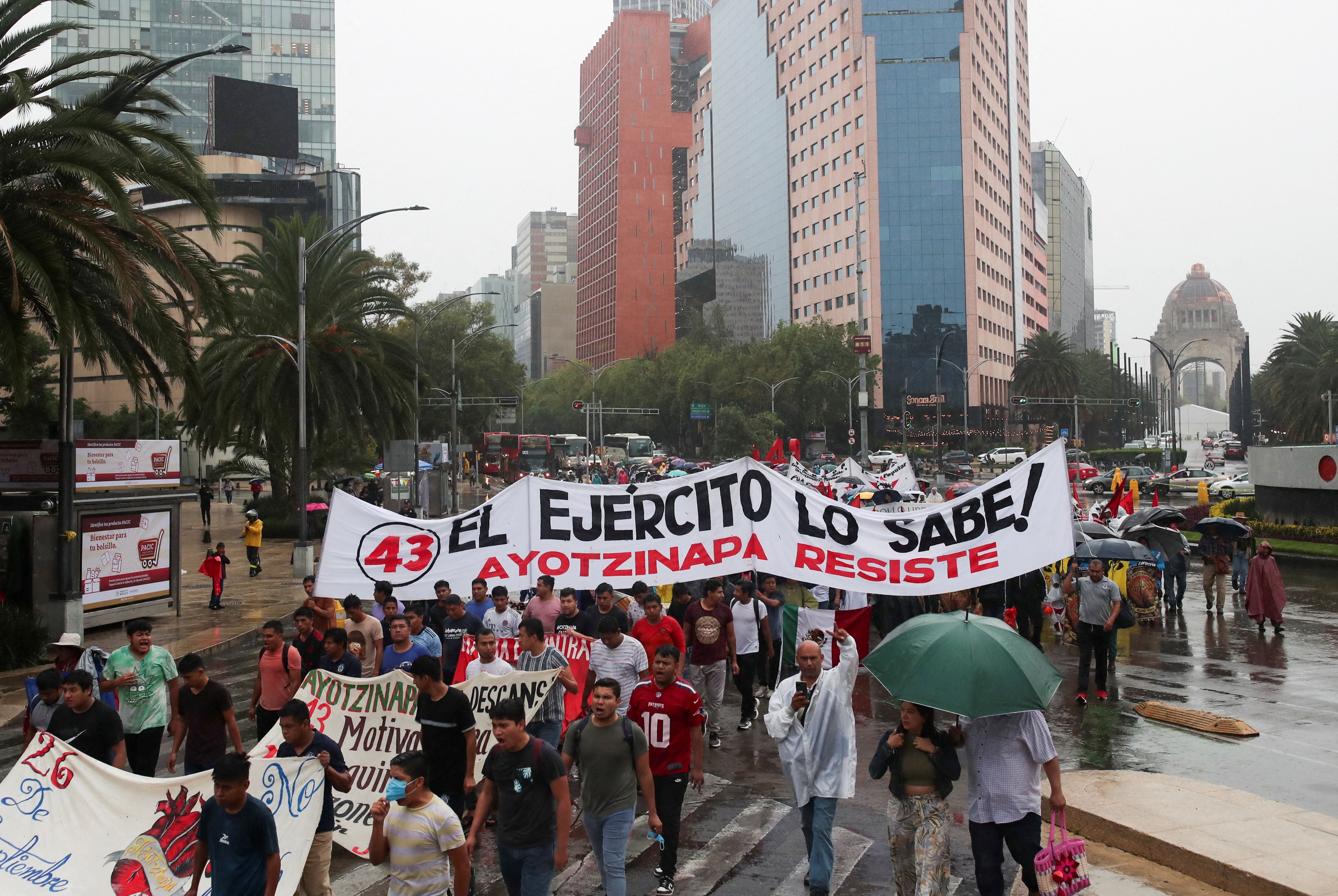 FILE PHOTO: People take part in a march to demand justice for the 43 students from the Ayotzinapa Teacher Training College, in Mexico City, Mexico July 26, 2023. The banner reads "The army knows". REUTERS/Henry Romero/File Photo