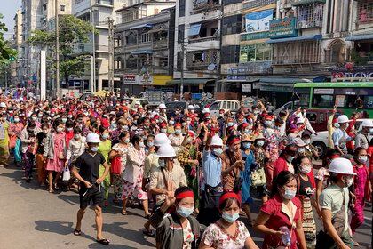 In this image from video, a crowd of protesters march in Yangon, Myanmar Saturday, Feb. 6, 2021. The military authorities in charge of Myanmar broadened a ban on social media following this week’s coup, shutting access to Twitter and Instagram, while street protests continued to expand Saturday as people gathered again to show their opposition to the army takeover. (AP Photo)