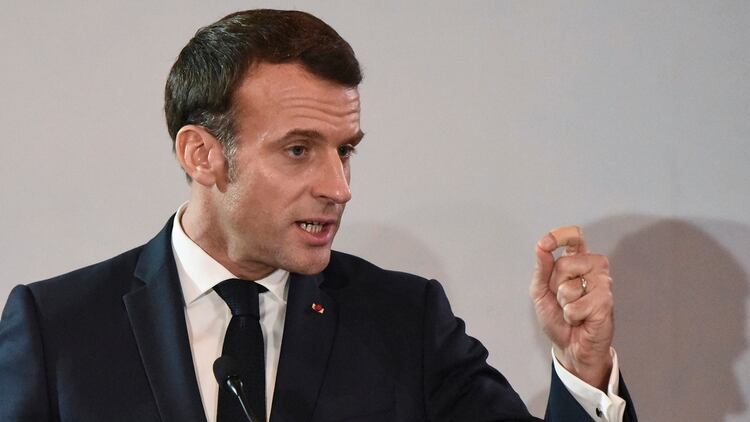 French President Emmanuel Macron gestures during a press conference at the Presidential Palace in Abidjan on December 21, 2019, as part of a three day visit to West Africa. (Photo by SIA KAMBOU / AFP)