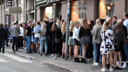 FILE PHOTO: People queue in front of a night club after the coronavirus disease (COVID-19) restrictions for restaurants, bars and nightclubs were lifted, in Helsinki, Finland July 15, 2020. Jussi Nukari/Lehtikuva /via REUTERS