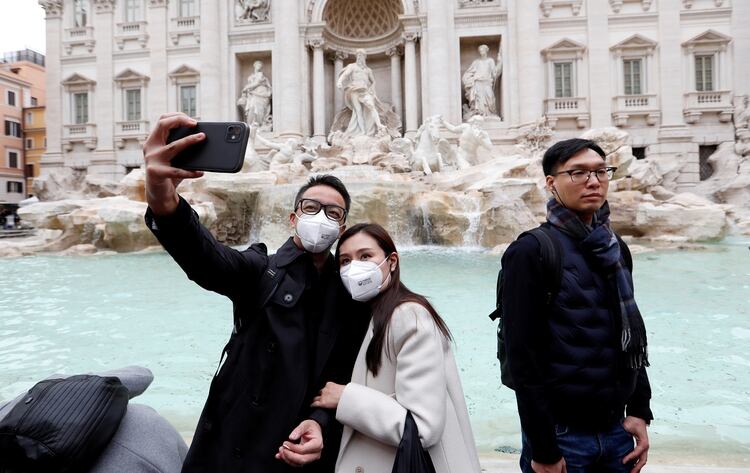 Turistas chinos con mascarillas en las Fontana de Trevi, Italia (REUTERS/Remo Casilli)