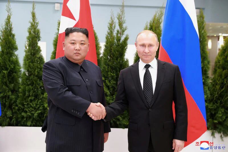 FILE PHOTO: North Korean leader Kim Jong Un shakes hands with Russian President Vladimir Putin in Vladivostok, Russia, in this April 25, 2019 photo released by the North's Korean Central News Agency (KCNA).  KCNA via REUTERS