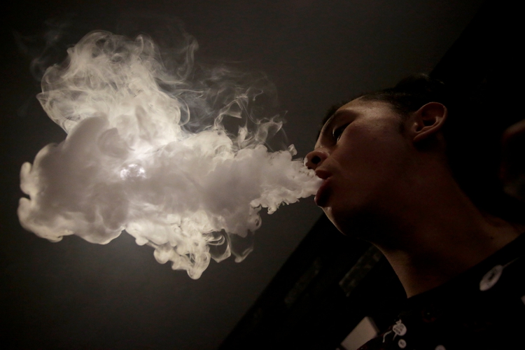 A man poses for a picture as he vapes at a Vape Shop in Monterrey, Mexico February 1, 2019. Picture taken February 1, 2019. FREUTERS/Daniel Becerril