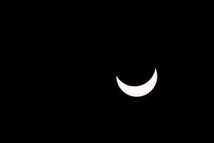 A partial solar eclipse is pictured in Buenos Aires, Argentina, December 14, 2020. REUTERS/Agustin Marcarian