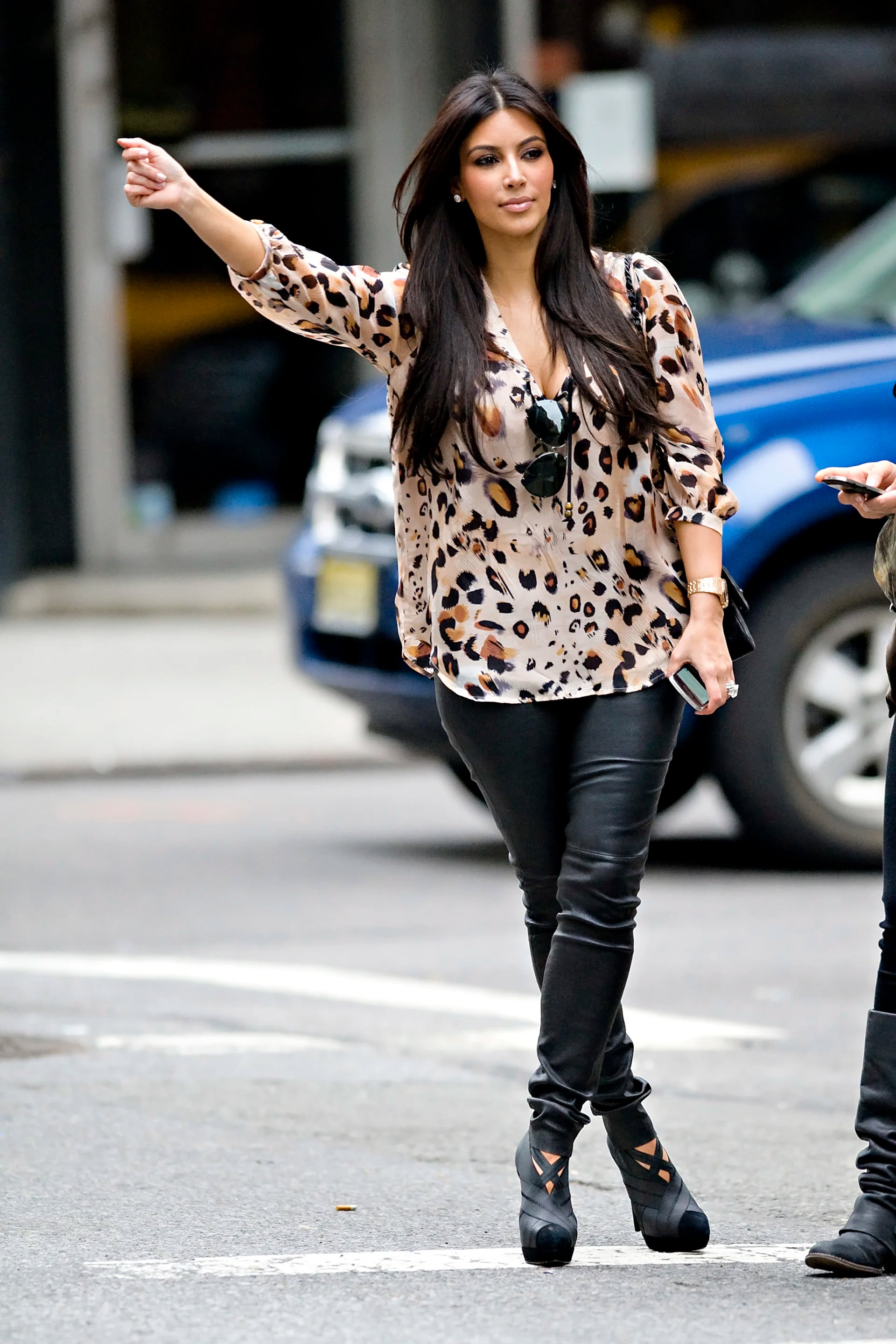 Kim Kardashian seen wearing leopard print top and leather pants hailing a cab in NYC.