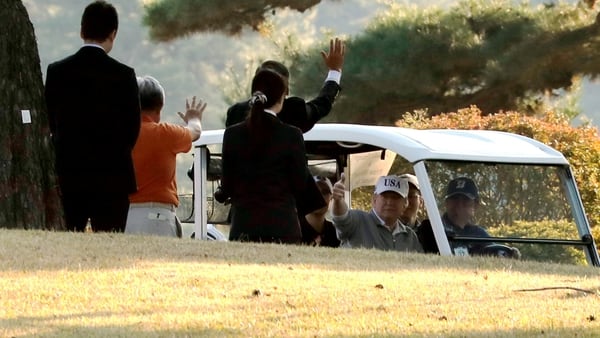 Trump en el carro de golf junto al primer ministro nipón Shinzo Abe. (Reuters)