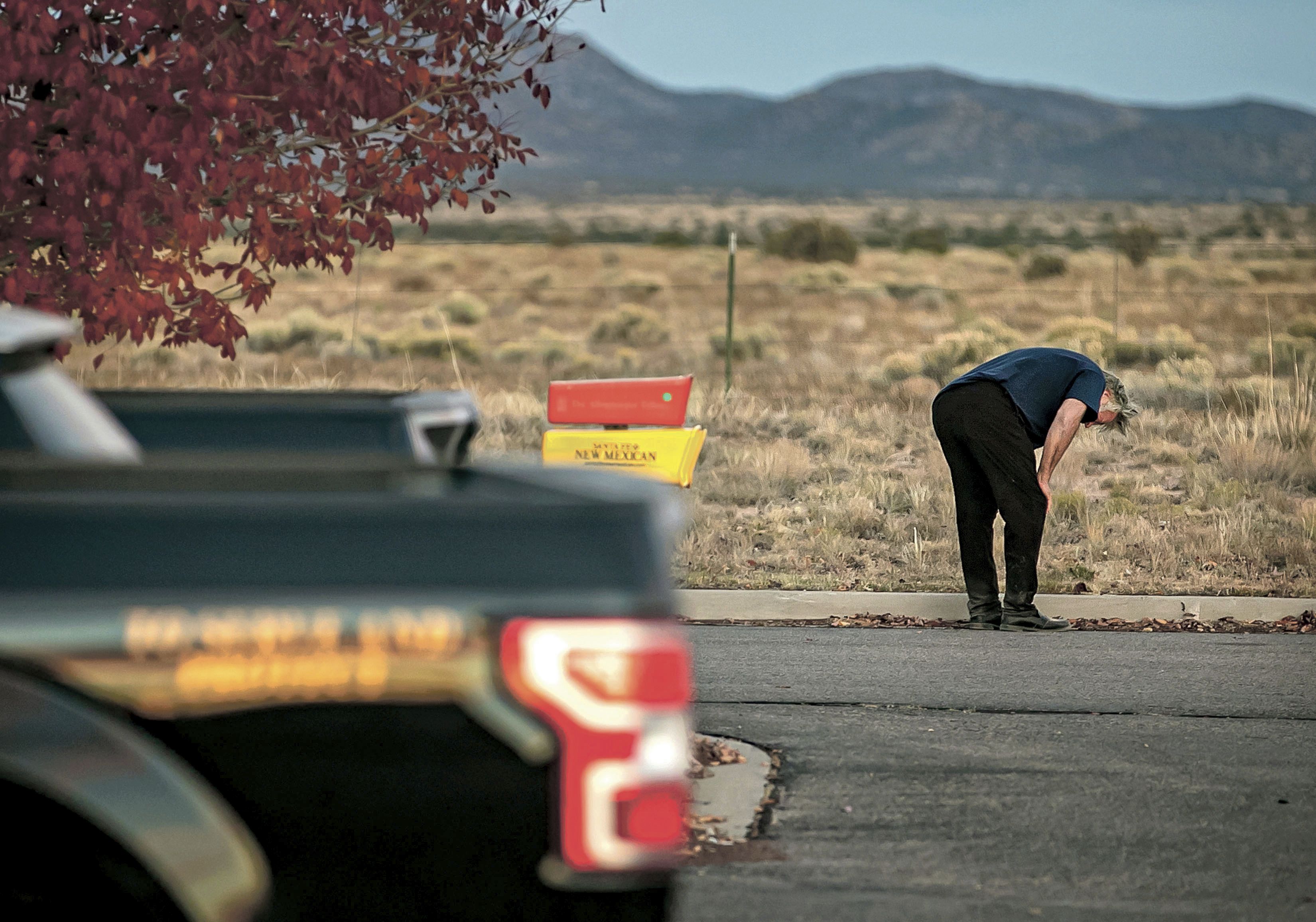 A distraught Alec Baldwin lingers in the parking lot outside the Santa Fe County Sheriff's Office in Santa Fe, N.M., after he was questioned about a shooting on the set of the film "Rust" on the outskirts of Santa Fe, Thursday, Oct. 21, 2021. Baldwin fired a prop gun on the set, killing cinematographer Halyna Hutchins and wounding director Joel Souza, officials said. (Jim Weber/Santa Fe New Mexican via AP)