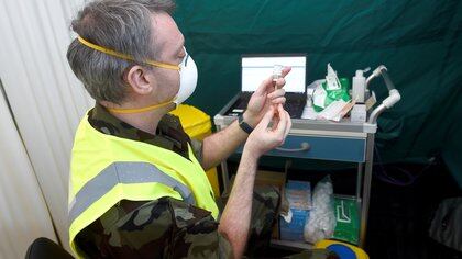 St. James?s Hospital Infectious Diseases Specialist Registrar and Irish Army Reserve Dr Colm Kerr prepares a dose of AstraZeneca coronavirus disease (COVID-19) vaccine at an HSE vaccination centre outside St. Mary's Hospital, in Phoenix Park in Dublin, Ireland, February 14, 2021.  REUTERS/Clodagh Kilcoyne