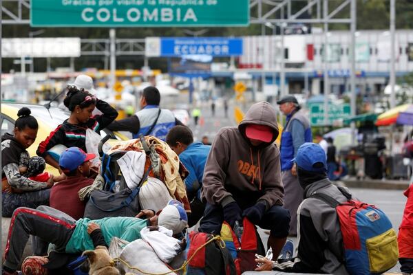 Venezuelans wait to cross the border between Colombia and Ecuador after Ecuador's government on Saturday announced the closure of its borders from Sunday to all foreign travelers due to the spread of the coronavirus, picture taken from the side of Ipiales, Colombia, March 15, 2020. REUTERS/Daniel Tapia