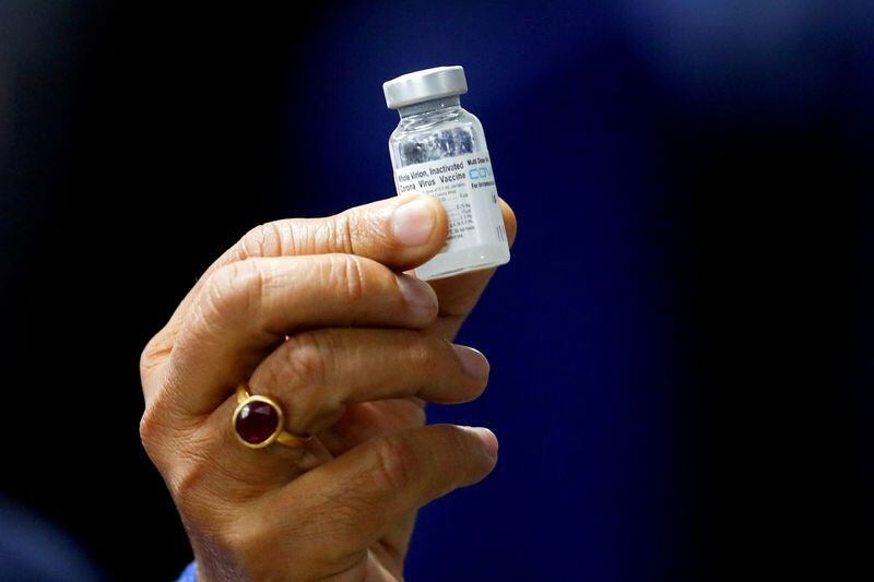 FILE PHOTO: Indian Health Minister Harsh Vardhan holds a dose of Bharat Biotech's COVID-19 vaccine called COVAXIN, during a vaccination campaign at All India Institute of Medical Sciences (AIIMS) hospital in New Delhi, India, January 16, 2021. REUTERS/Adnan Abidi/File Photo