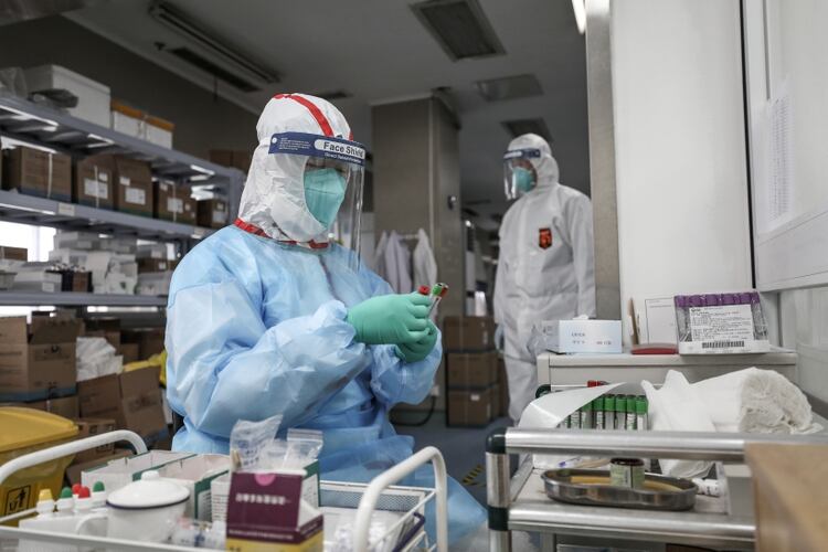 Un médico examina una prueba de diagnóstico del virus en Wuhan (Reuters)
