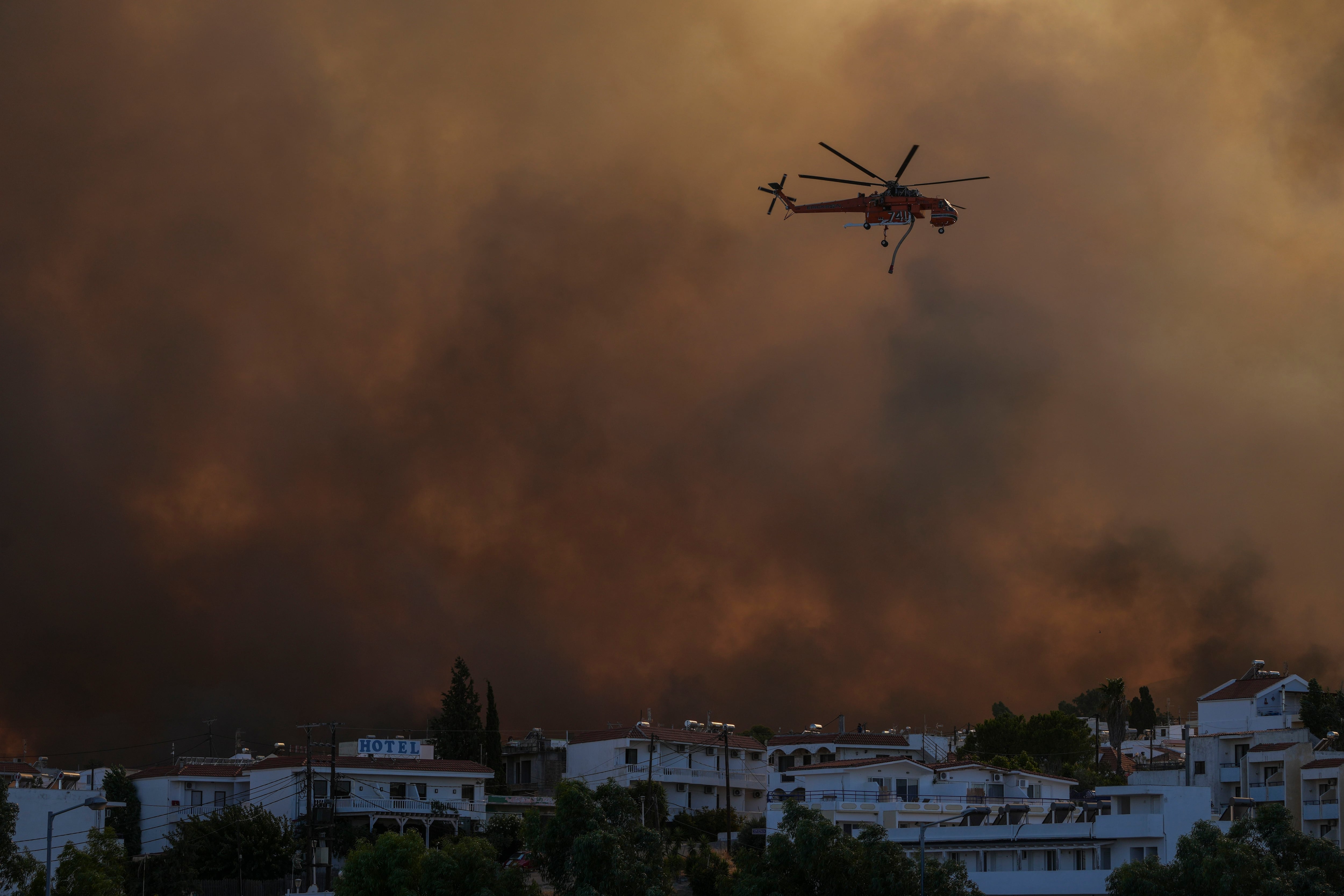 Los incendios provocaron caos en el pico de la ajetreada temporada turística de verano en Grecia. Unos 20.000 turistas y habitantes tuvieron que ser evacuados. (AP Foto/Petros Giannakouris)