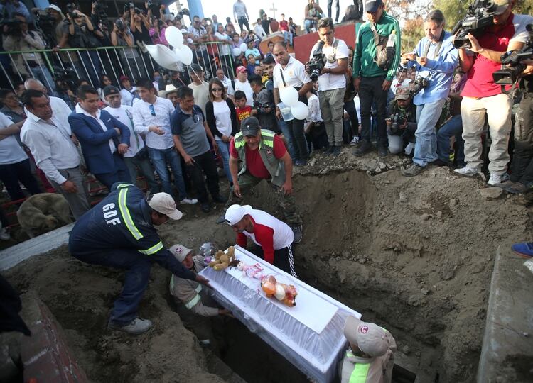 The coffin of seven-year-old Fatima Cecilia Aldrighett, who went missing and whose body was discovered inside a plastic bag, is lowered during her funeral in Mexico City, Mexico, February 18, 2020. REUTERS/Edgard Garrido