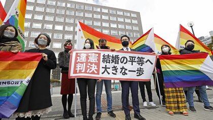 Plaintiffs' lawyers and supporters show a banner that reads 'Unconstitutional decision' after a district court ruled on the legality of same-sex marriages outside Sapporo district court in Sapporo, Hokkaido, northern Japan March 17, 2021, in this photo taken by Kyodo. Mandatory credit Kyodo/via REUTERS   ATTENTION EDITORS - THIS IMAGE WAS PROVIDED BY A THIRD PARTY. MANDATORY CREDIT. JAPAN OUT. NO COMMERCIAL OR EDITORIAL SALES IN JAPAN.