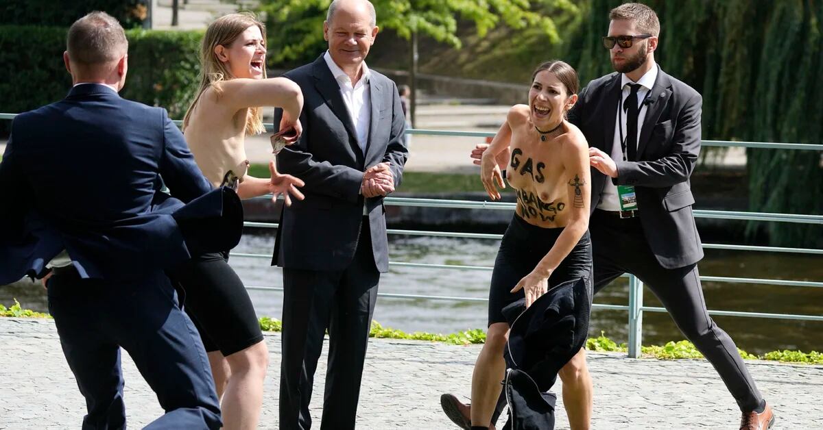 The shirtless protest caught German Chancellor Olaf Scholz by surprise