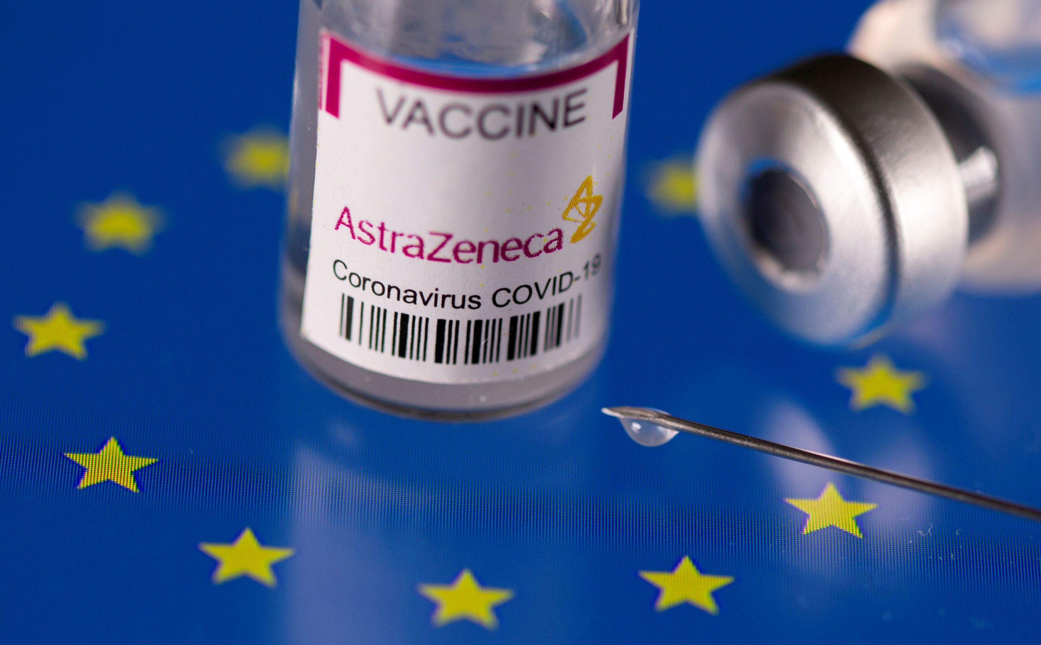 FILE PHOTO: Vials labelled "AstraZeneca coronavirus disease (COVID-19) vaccine" placed on displayed EU flag are seen in this illustration picture taken March 24, 2021. REUTERS/Dado Ruvic/Illustration/File Photo
