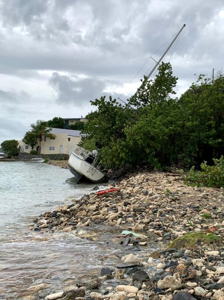 A washed up boat lies along the shore as Hurricane Dorian slams into St. Thomas, U.S. Virgin Islands August 28, 2019 in this image obtained by Reuters on August 29, 2019. Michelle Robbins via REUTERS THIS IMAGE HAS BEEN SUPPLIED BY A THIRD PARTY. MANDATORY CREDIT. NO RESALES. NO ARCHIVES.