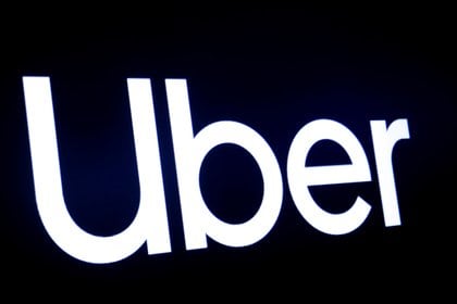 FILE PHOTO: A screen displays the company logo for Uber Technologies Inc at the New York Stock Exchange (NYSE) in New York, U.S., May 10, 2019. REUTERS/Brendan McDermid/File Photo