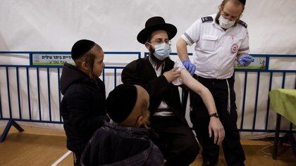 An ultra-Orthodox Jewish man receives a vaccination against the coronavirus disease (COVID-19) at a temporary vaccination centre in the Jewish settlement of Beitar Illit, in the Israeli-occupied West Bank February 16, 2021. Picture taken February 16, 2021. REUTERS/Ronen Zvulun