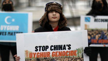 FILE PHOTO: People take part in a rally to encourage Canada and other countries as they consider labeling China's treatment of its Uighur population and Muslim minorities as genocide, outside the Canadian Embassy in Washington, D.C., U.S. February 19, 2021. REUTERS/Leah Millis/File Photo
