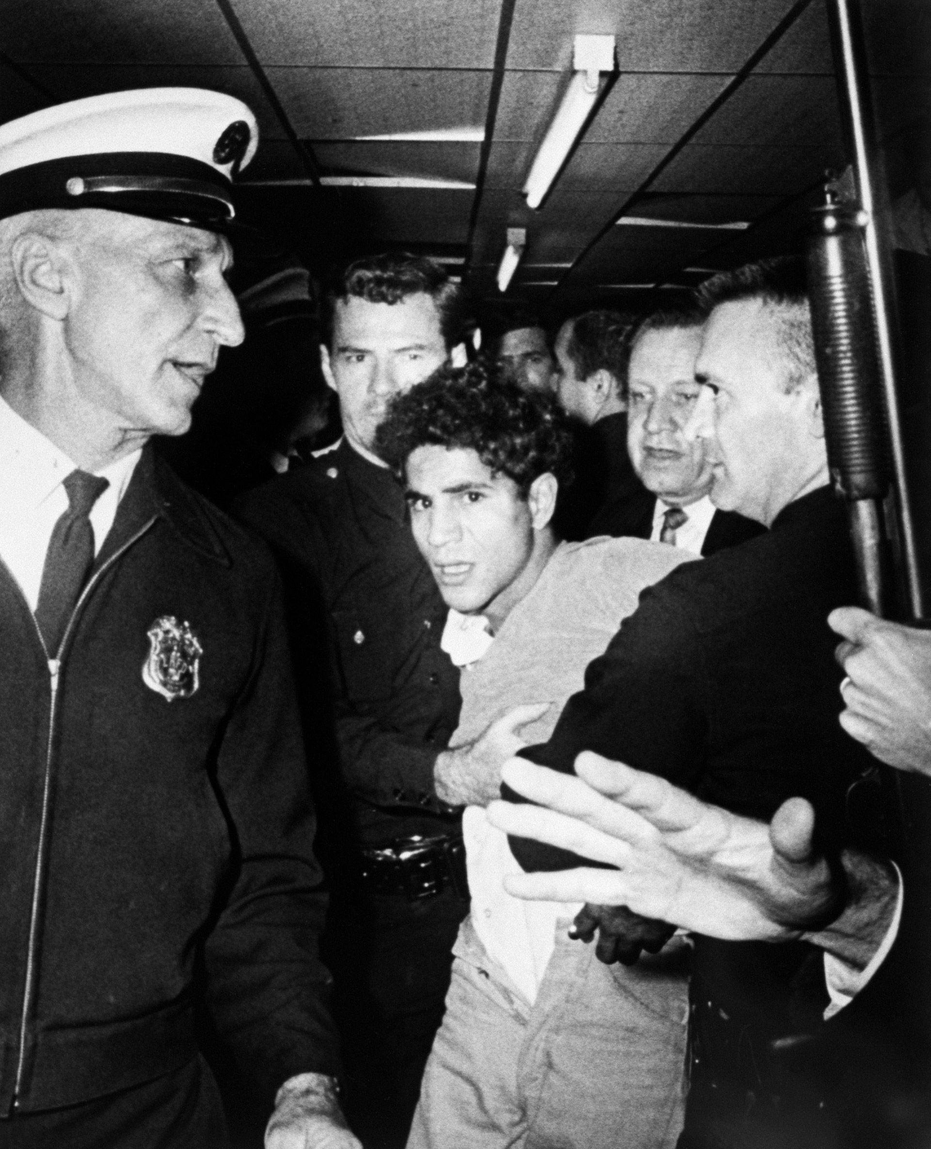 Sirhan Sirhan is led away from the Ambassador Hotel after shooting Robert F. Kennedy