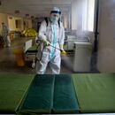 A worker in protective suit disinfects the Wuhan No. 7 Hospital, once a designated hospital for coronavirus disease (COVID-19) patients, to prepare it for the resumption of its normal service in Wuhan, Hubei province, China March 19, 2020. cnsphoto via REUTERS ATTENTION EDITORS - THIS IMAGE WAS PROVIDED BY A THIRD PARTY. CHINA OUT.