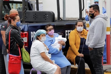 Patients are seen outside a hospital treating people with the coronavirus disease (COVID-19), in the aftermath of a quake, in Puebla, Mexico June 23, 2020. REUTERS/Imelda Medina