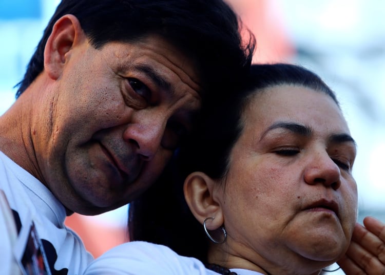 Fernando Baez Sosa's parents, Silvio Baez and Graciela Sosa, a 19-year-old who was beaten to death a month ago in the coastal resort of Villa Gesell in Buenos Aires province, mourn his death during a protest outside of National Congress, in Buenos Aires, Argentina February 18, 2020. REUTERS/Matias Baglietto
