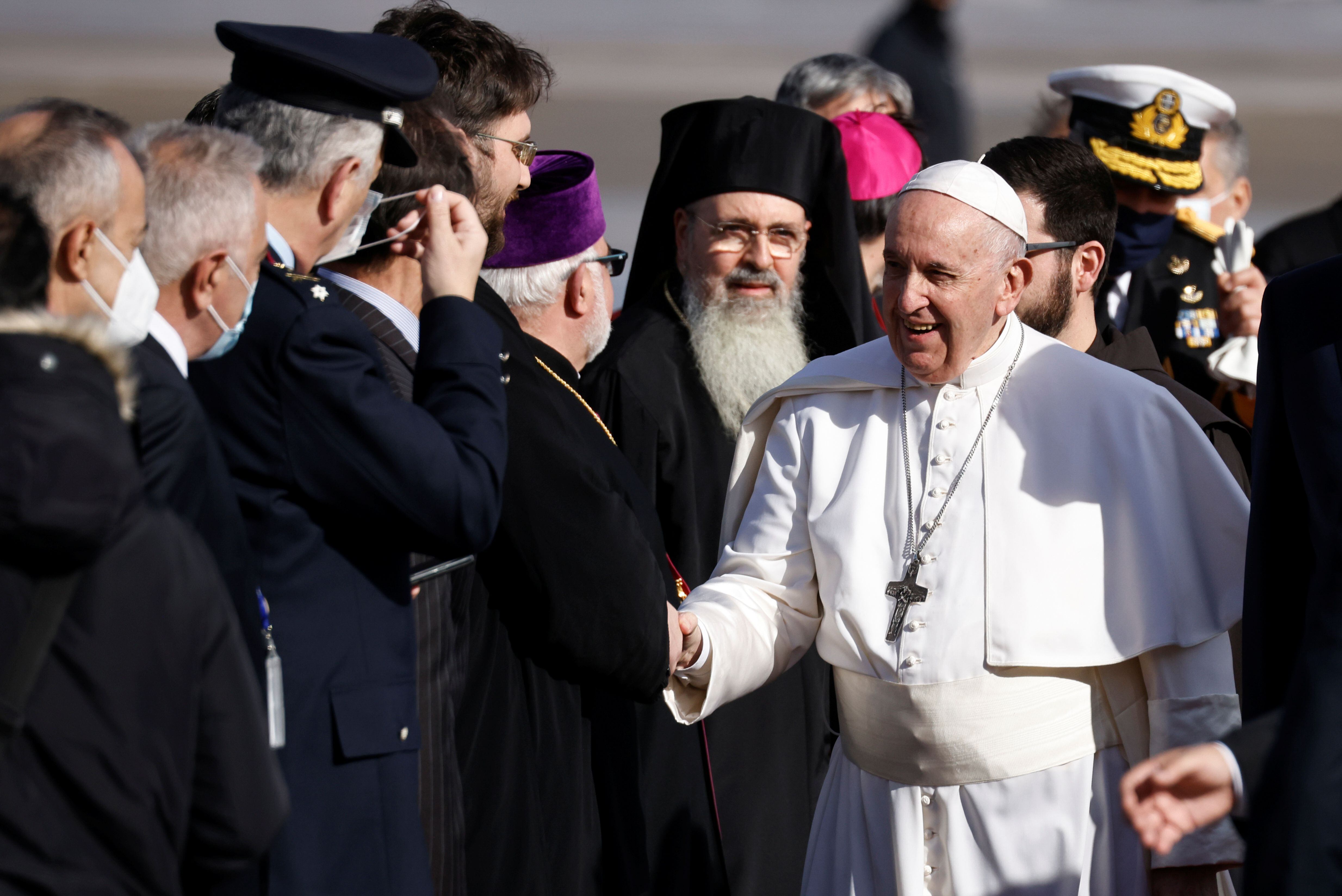Pope Francis greets people upon arrival at the Athens International Airport in Athens, Greece, on December 4, 2021. REUTERS / Alkis Konstantinidis