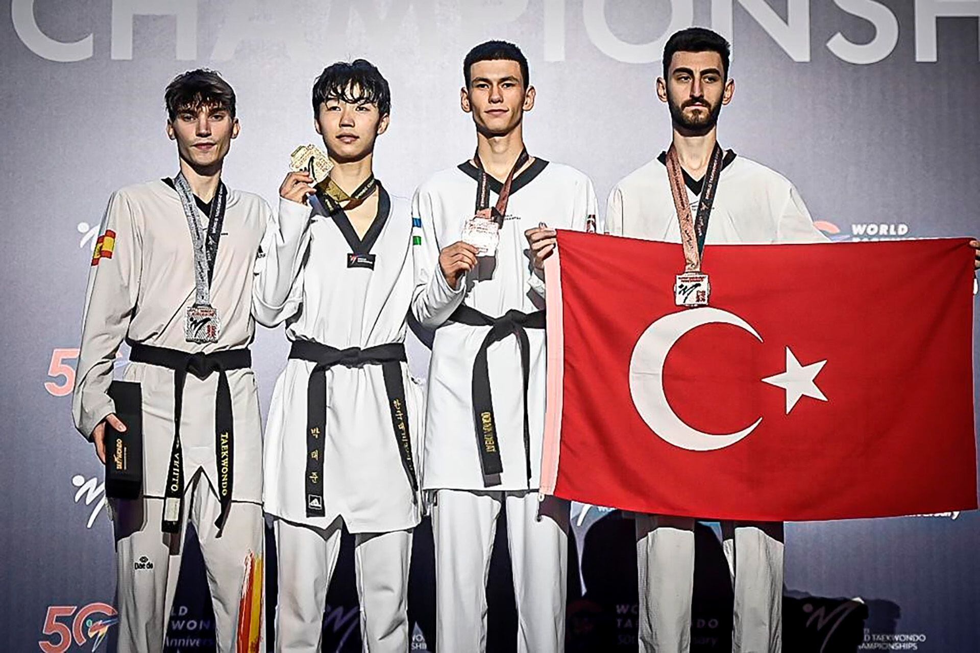 The -54 kg medalists: Hugo Arillo Vázquez (Spain, silver) Tae-Joon Park (Republic of Korea, gold), Omonjov Ttajonov (Uzbekistan, bronze) and Gorkem Polat (Turkey, bronze). World Taekwondo.