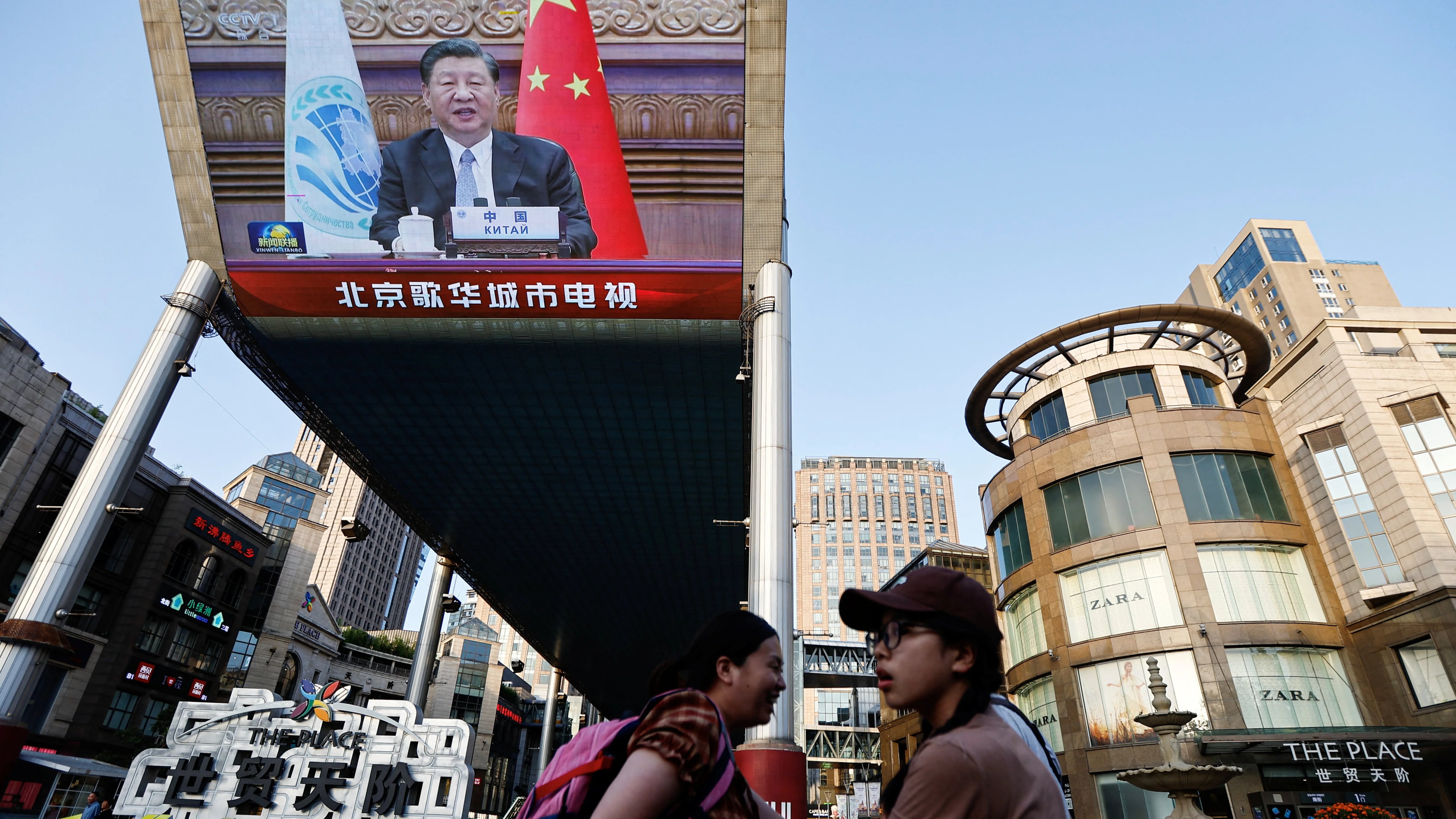 A giant screen broadcasts news footage of Chinese President Xi Jinping attending via video link the meeting of the Shanghai Cooperation Organisation Council of Heads of State, in Beijing, China July 4, 2023. REUTERS/Tingshu Wang