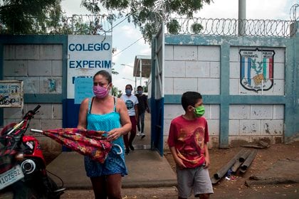 Una mujer junto a su hijo utilizan tapabocas al salir de una escuela en Managua (Nicaragua). EFE/Jorge Torres/Archivo
