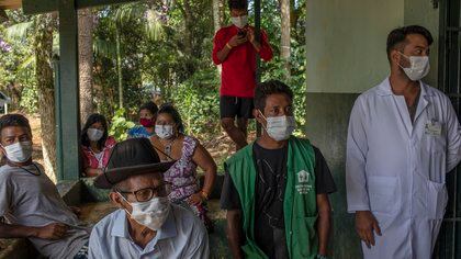 Brazilian indigenous people waited in Sao Paulo on Jan. 20, 2021, to receive the COVID-19 vaccine from the Chinese company Sinovac. Brazilian officials have complained that Chinese companies have been slow to ship the doses and ingredients. (Victor Moriyama/The New York Times)