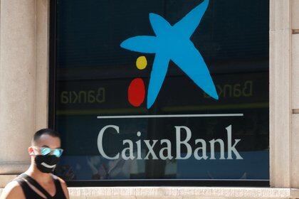 A man walks past a Caixabanka's bank office near Barcelona during the coronavirus disease (COVID-19) outbreak in Barcelona, Spain, September 14, 2020. REUTERS/ Albert Gea