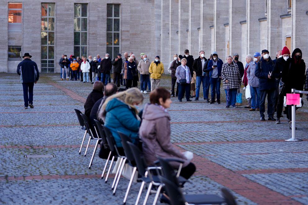Personas hacen fila para ser vacunados en el centro de vacunación del servicio de ayuda Malteser en el recinto ferial de Berlín, Alemania, el miércoles 3 de noviembre de 2021. (AP /Markus Schreiber)