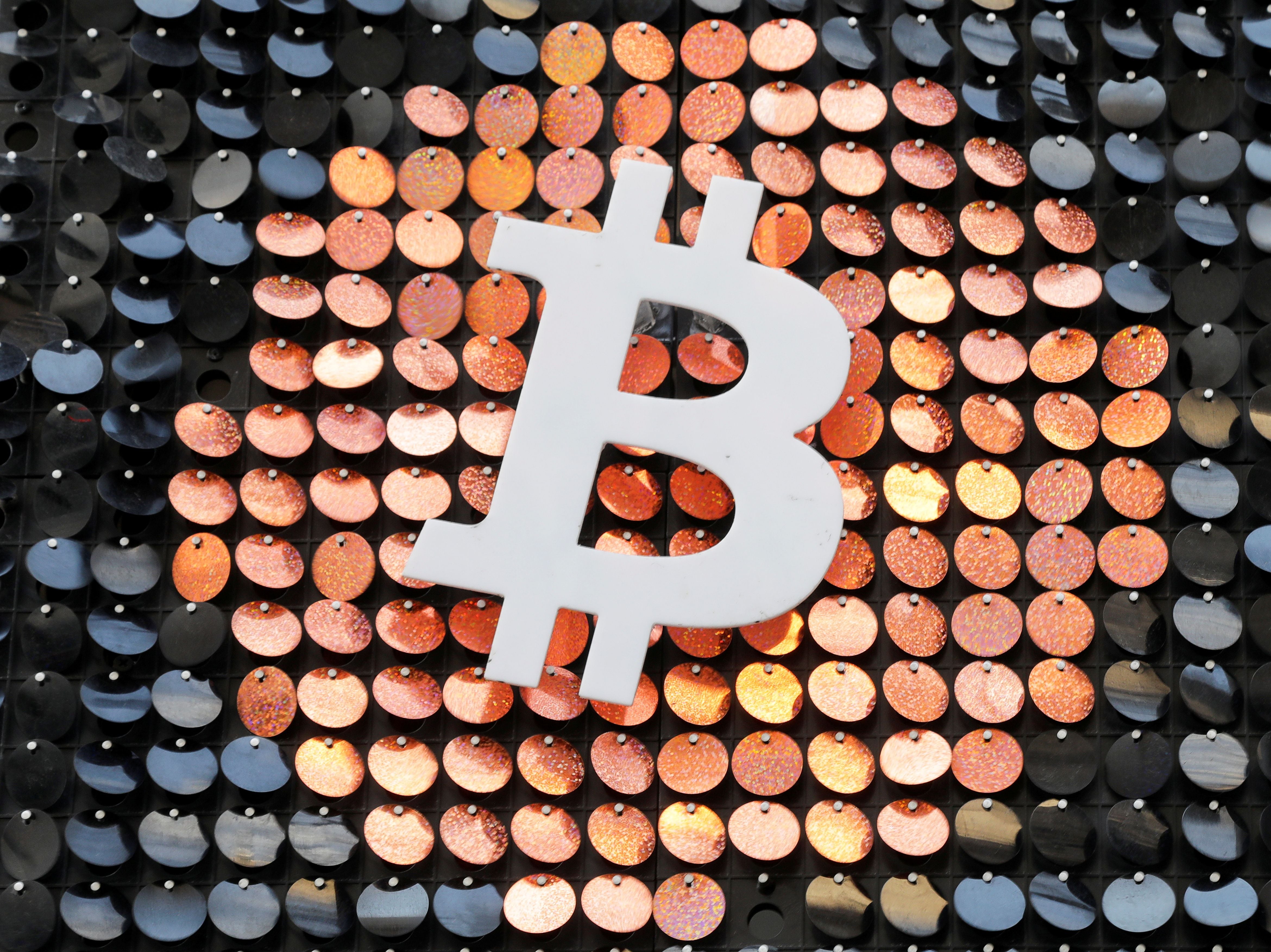FILE PHOTO: FILE PHOTO: The logo of the Bitcoin digital currency is seen in a shop in Marseille, France, February 7, 2021. REUTERS/Eric Gaillard/File Photo/File Photo