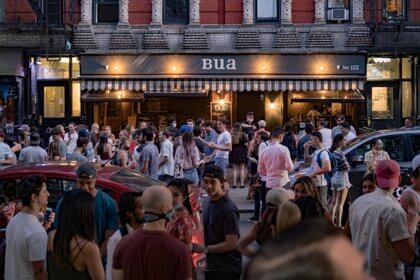 People drink outside a bar during the reopening phase following the coronavirus disease (COVID-19) outbreak in the East Village neighborhood in New York City, U.S., June 12, 2020. Picture taken June 12, 2020. REUTERS/Jeenah Moon     TPX IMAGES OF THE DAY