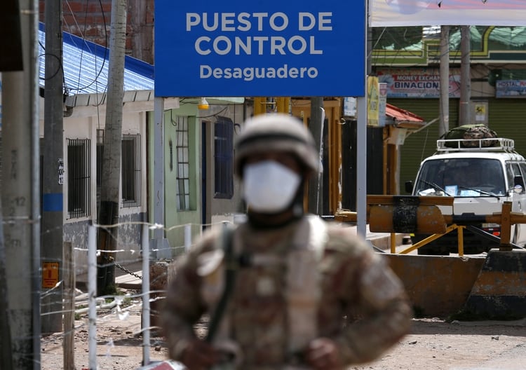 A Peruvian soldier stands at the check point in border line between Peru and Bolivia after Peru's government's announcement of the border closure in a bid to slow the spread of the new coronavirus (COVID-19), in Desaguadero, Bolivia, March 17, 2020. REUTERS/David Mercado