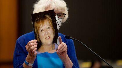 Dolly Kreis holds a photo of her daughter Deborah Strouse at the podium and shows it towards Joseph James DeAngelo, known as the Golden State Killer, on the first day of victim impact statements at the Gordon D. Schaber Sacramento County Courthouse in Sacramento, California, U.S. August 18, 2020  Santiago Mejia/Pool via REUTERS