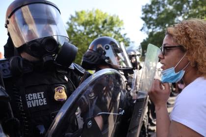 A demonstrator faces U.S. Secret Service uniformed division officers during a rally near the White House against the death in Minneapolis police custody of George Floyd, in Washington, D.C., U.S., June 1, 2020. REUTERS/Jonathan Ernst