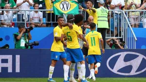 Soccer Football – World Cup – Round of 16 – Brazil vs Mexico – Samara Arena, Samara, Russia – July 2, 2018 Brazil’s Neymar (hidden) celebrates scoring their first goal with team mates REUTERS/Michael Dalder